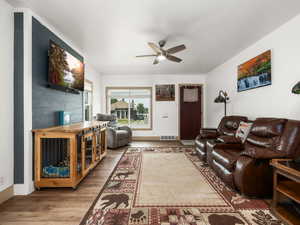 Living room featuring ceiling fan and wood finished floors