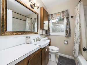 Full bathroom featuring vanity, tile patterned floors, and shower / bath combination with curtain