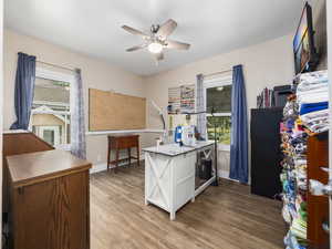 Office space with ceiling fan and light wood finished floors