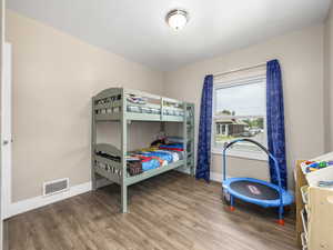 Bedroom featuring baseboards and wood finished floors