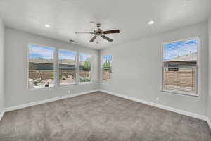 Spare room featuring carpet, ceiling fan, and recessed lighting