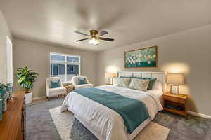 Carpeted bedroom with baseboards and ceiling fan