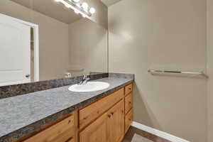 Bathroom featuring vanity and baseboards