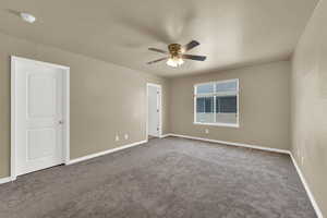 Empty room with a ceiling fan, carpet floors, and a smoke detector