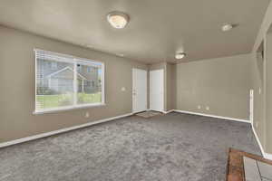 Unfurnished room featuring carpet flooring and a smoke detector