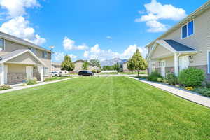 View of green lawn featuring a mountain view and a residential view