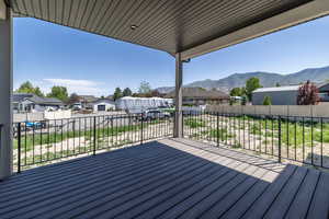 Wooden terrace featuring a residential view and a mountain view