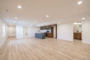 Unfurnished living room with light wood-style floors and recessed lighting