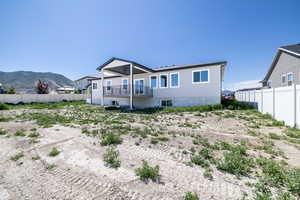 Back of property featuring a mountain view and a balcony