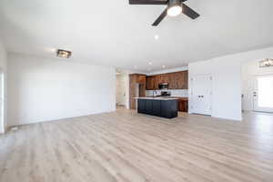 Unfurnished living room with light wood-style flooring, recessed lighting, and ceiling fan