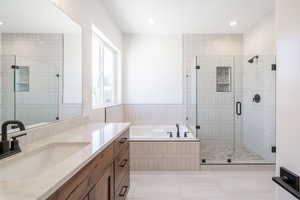 Bathroom with vanity, a bath, a shower stall, and recessed lighting