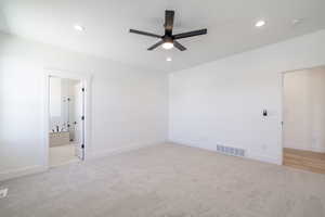 Empty room featuring a ceiling fan, light colored carpet, recessed lighting, and a smoke detector