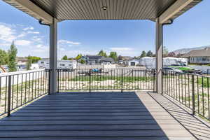 Deck with a residential view and a mountain view