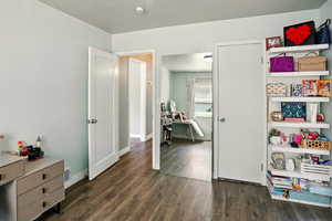 Bedroom with dark wood-type flooring