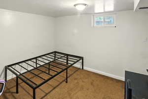 Unfurnished bedroom featuring carpet floors and a textured ceiling