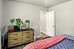 Bedroom featuring wood finished floors and baseboards