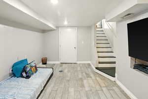 Finished below grade area featuring wood finished floors and stairway