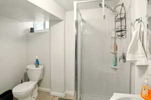Full bath with a shower stall and wood finished floors