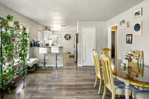 Dining area featuring wood finished floors and baseboards