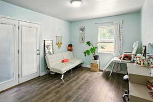 Living area with dark wood finished floors and baseboards