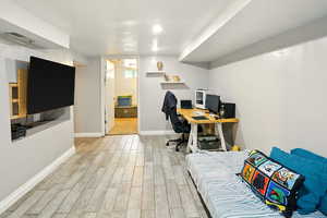 Office area with light wood-style flooring and baseboards