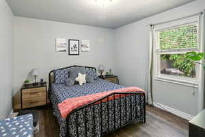 Bedroom featuring wood finished floors and baseboards