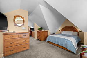 Upstairs third bedroom with built in queen sized frame and headboard, built in recessed nightstand shelves, two spacious built in dressers, built in TV shelf with hidden storage nook below, attached office area that could be walk in closet