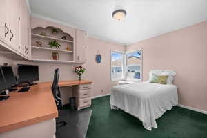 Main floor second bedroom featuring corner window with south and west daylight, built in desk and shelving
