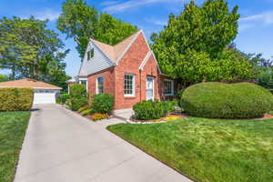 View of front of property featuring brick exterior and an oversized  2 car garage