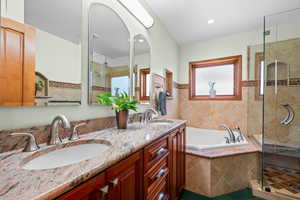 Bathroom vanity with granite countertop, double sinks, three recessed mirrored medicine cabinets with inside mirrors for back of the hair styling, dual flush toilet and built in cabinet for toilet brush by side of the toilet