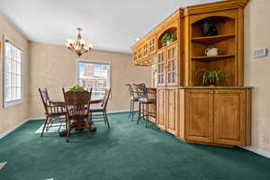 Dining room featuring built in cabinets, shelves and breakfast bar