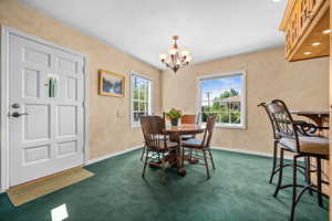 Dining room with hardwood floors under the carpet, natural east and southern light with breakfast bar