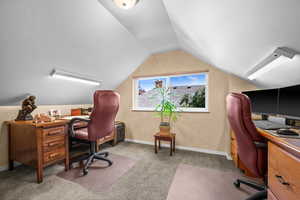 Upstairs office with built in desk with drawers, 4 filing cabinet drawers and cabinet for storage, built in bookshelves and north facing window