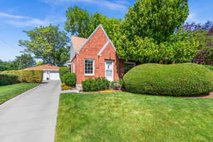View of front of property featuring brick exterior and an oversized 2 car garage