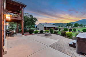 Patio / terrace featuring a mountain view, a patio area, a fire pit, and outdoor dining area
