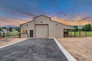 View of outdoor structure with a mountain view, asphalt driveway, and an exterior structure
