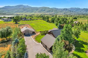 Aerial view of property and surrounding area with a mountainous background