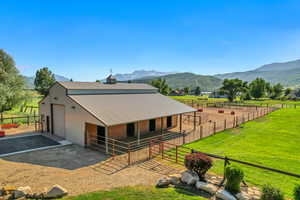 Horse barn featuring a mountain view and a view of countryside