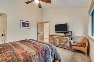 Carpeted bedroom featuring ceiling fan