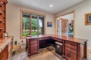 Office area with stone tile flooring and recessed lighting