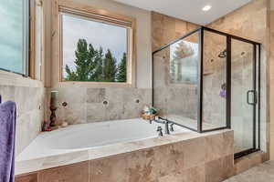 Full bath featuring a garden tub, a shower stall, and recessed lighting