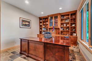 Office area with stone tile floors and recessed lighting