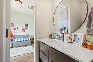 Bathroom featuring vanity and wood finished floors
