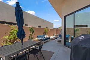 View of patio with an outdoor living space, a grill, and outdoor dining area