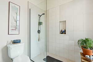 Bathroom with tiled shower and toilet