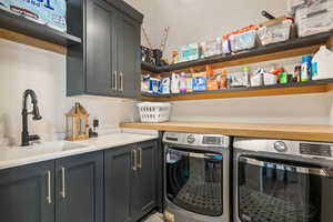 Washroom featuring cabinet space and washer and clothes dryer