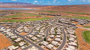 Aerial view of residential area featuring a water and mountain view and a local golf course
