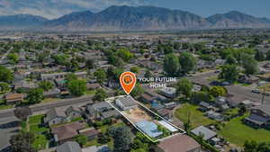 Aerial view of residential area featuring mountains and property boundaries highlighted