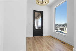 Foyer entrance featuring light wood finished floors and baseboards