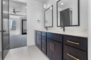 Full bath featuring double vanity, a ceiling fan, and recessed lighting